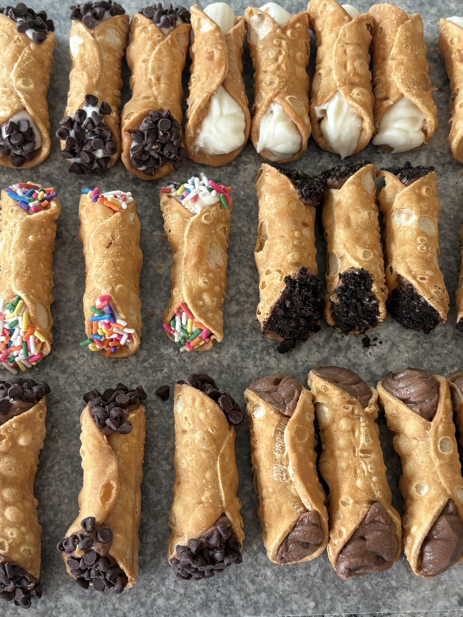 Assorted KeKe's Party Kart cannoli with different flavors and toppings